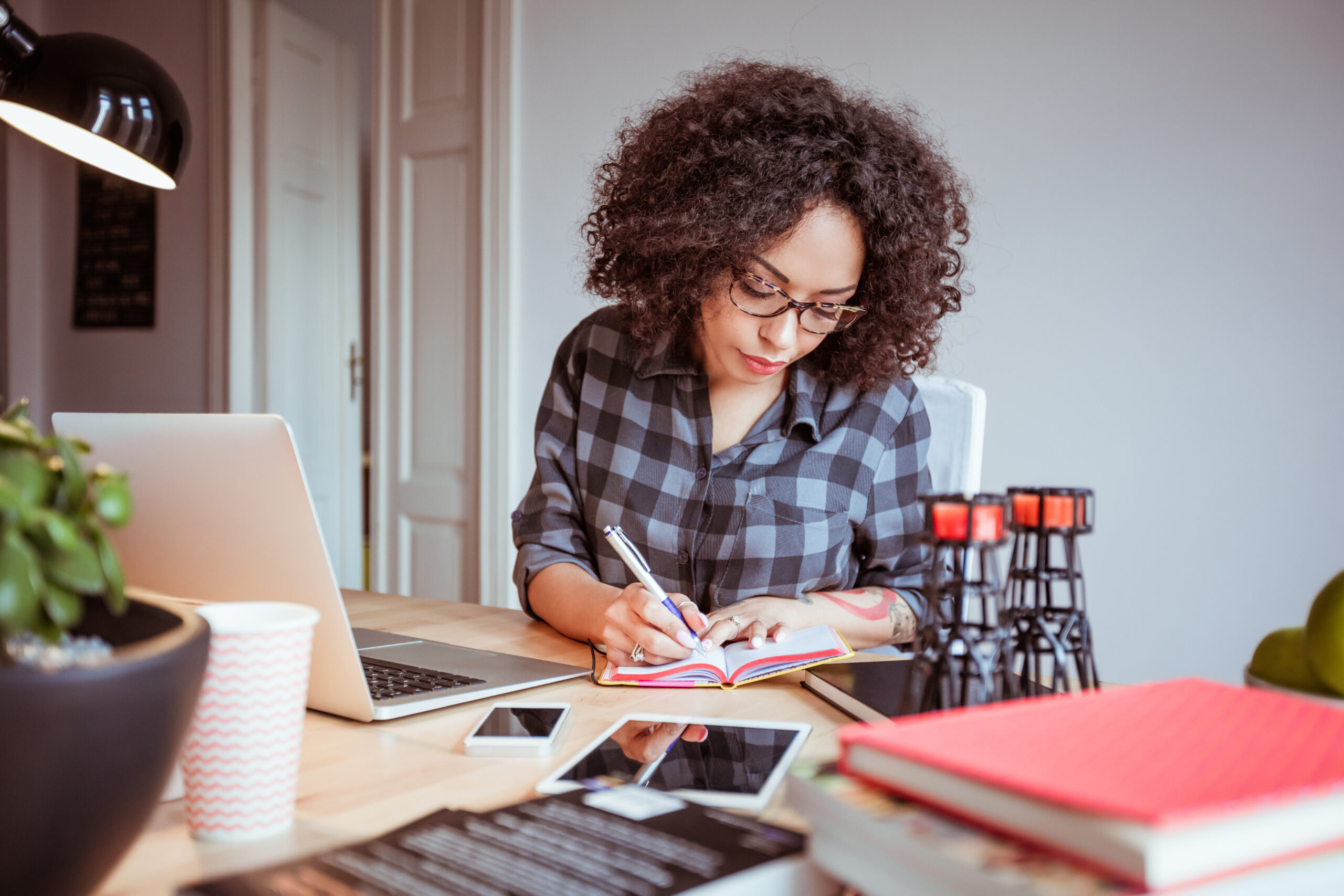 Woman taking notes in office