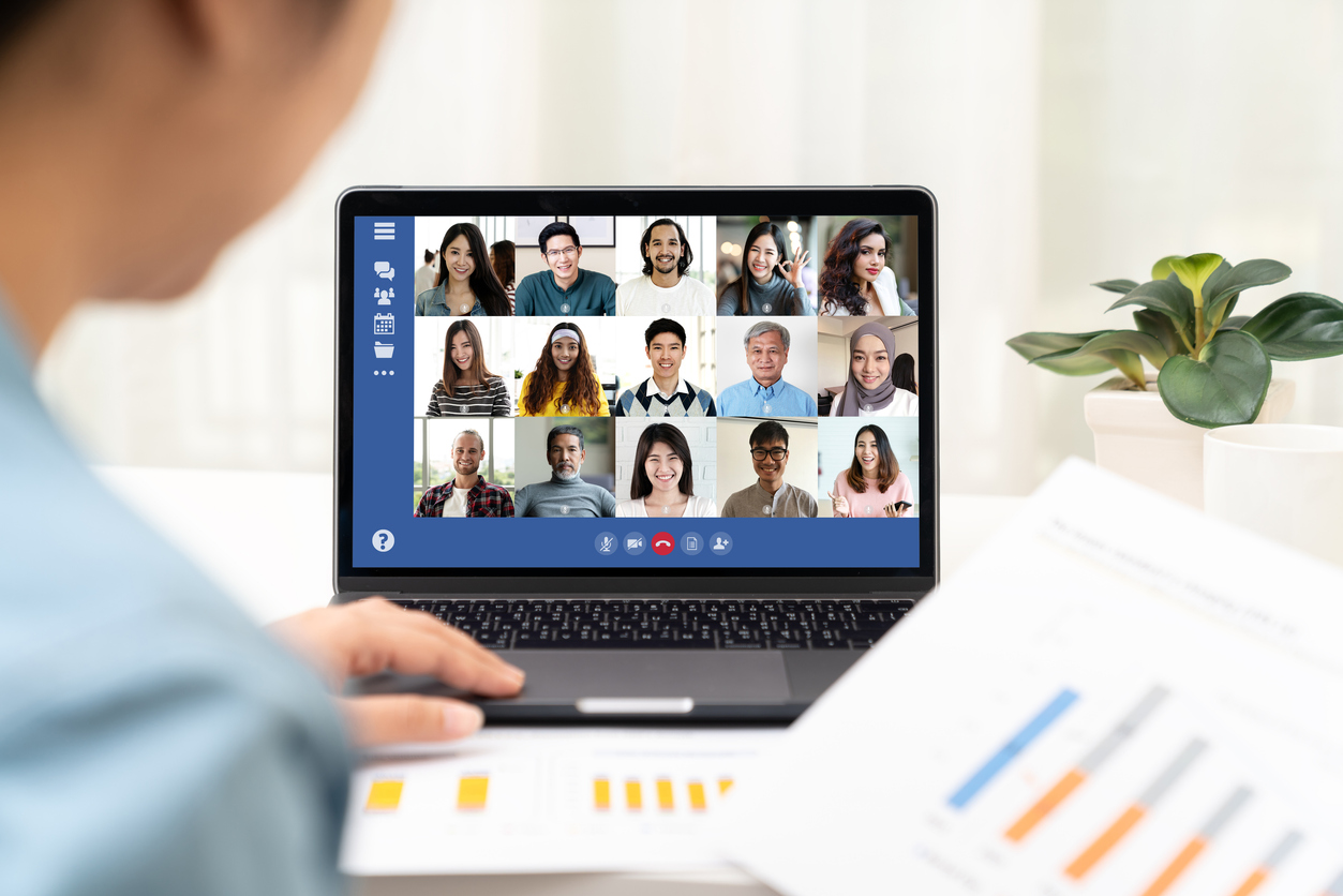 Back view of young asian business woman work remotely at home video conference remote call to corporate group. Meeting online,videocall, group discuss online concept with screen of teamwork on laptop.