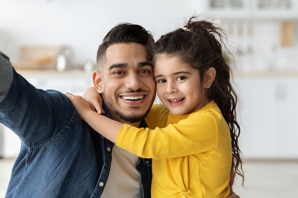 adult man holding a child
