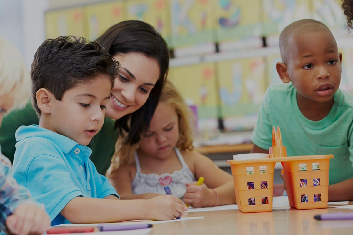 Teacher coloring with three students